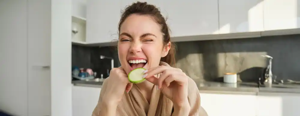 Woman eating a cucumber