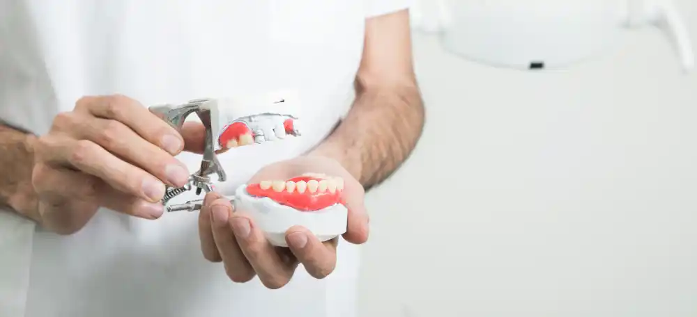 Man holding model of mouth