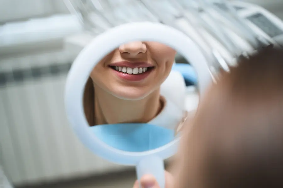 Close-Up of Woman's Smile in Dental Mirror